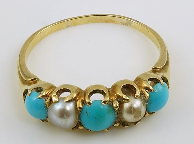 An early 20th century gold, three stone turquoise and two stone split pearl set half hoop ring